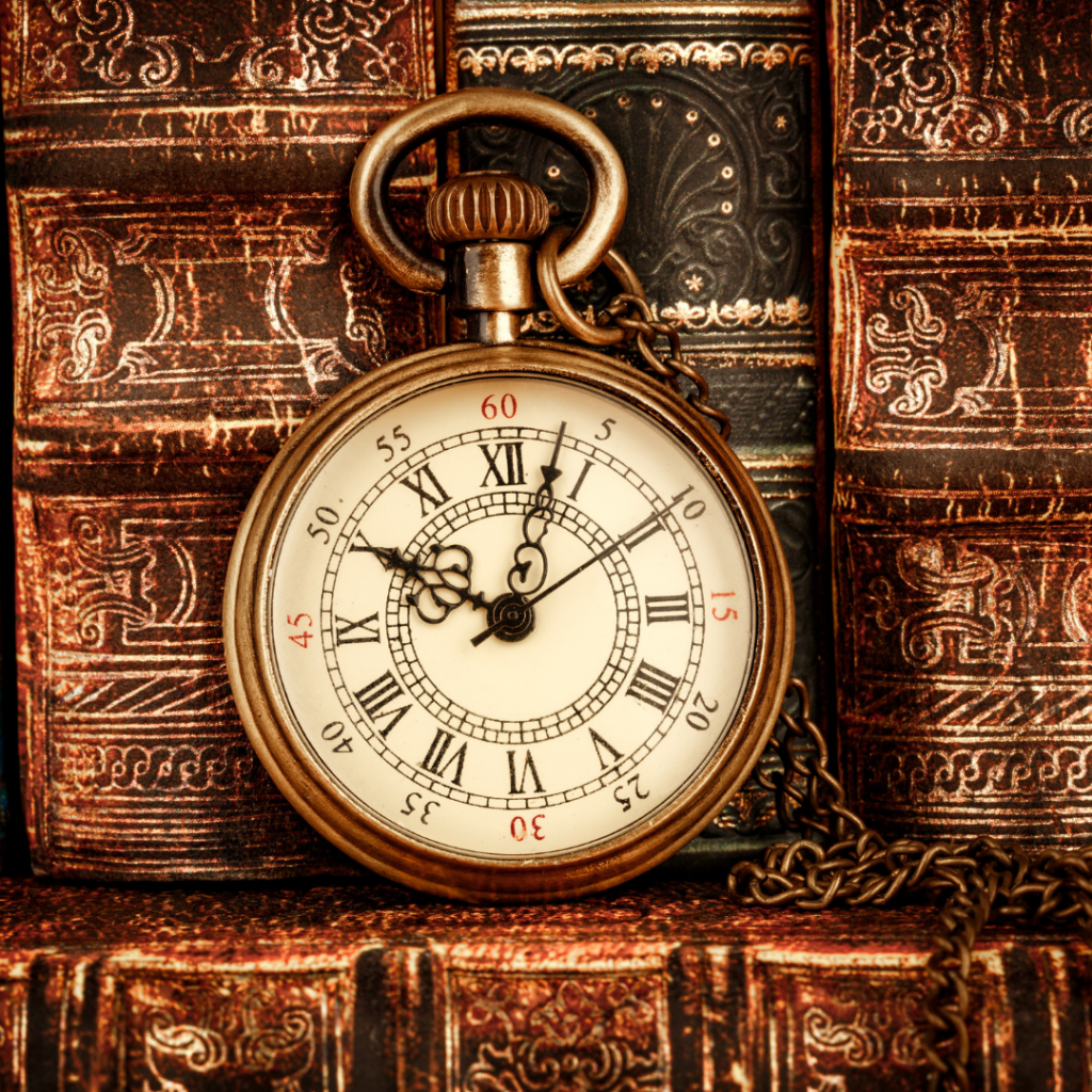 A pocket watch and leather bound books