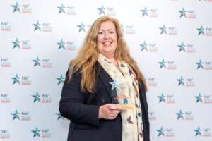 Katina Chapman holding her award