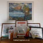 Image shows a picture of the bookcase in Katina's Norwich office with her awards and trophies for helping clients with hypnotherapy
