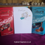 Photo of two boxes of Lindor chocolates and a Thank You card from a grateful client